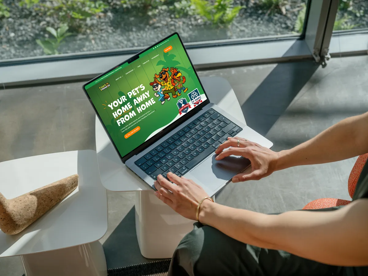 The Paws Paradise website open on a laptop
