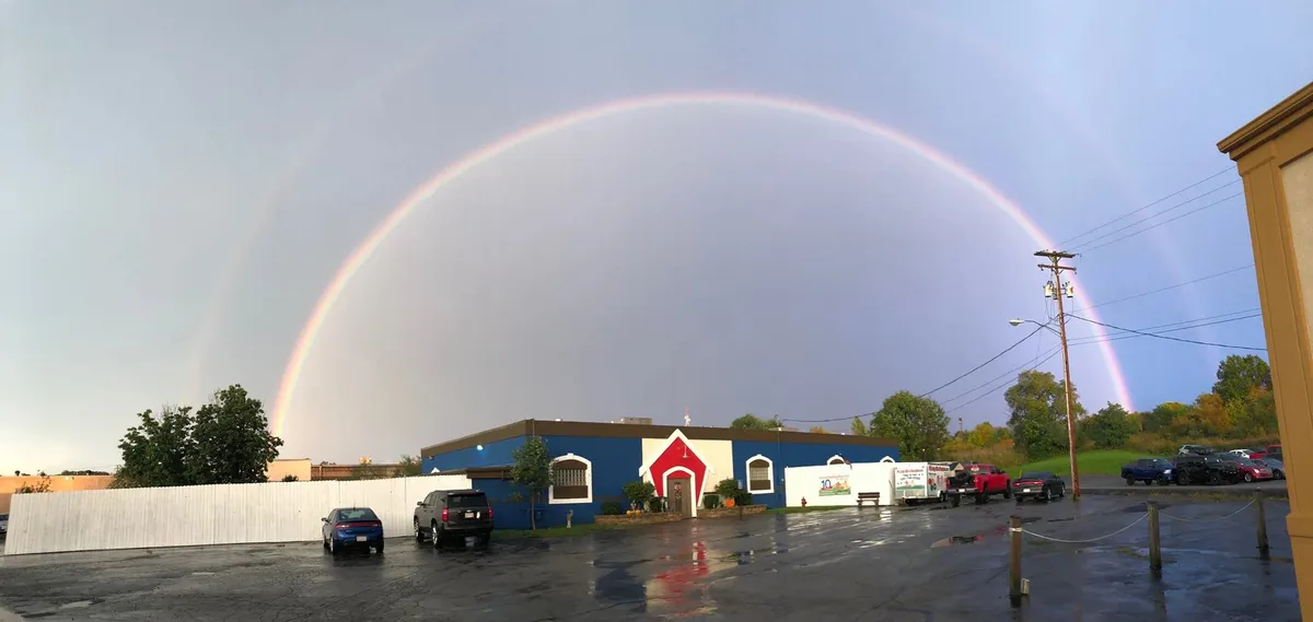 The Paws Paradise campus under a rainbow