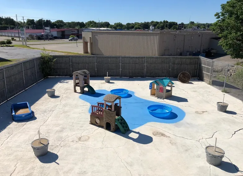 The Paws Paradise outdoor play yard with sand, pools and climbing toys